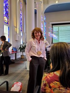 A picture of Erin Fraher, PhD, MPP with a medal for the Data Olympics 2019