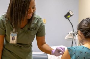 A photo of patient and medical assistant at Family Medicine.
