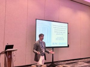 An image of Connor Sullivan presenting a slideshow