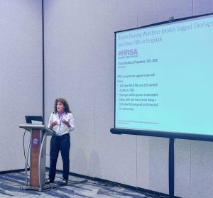 An image of Erin Fraher presenting a slideshow