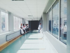 Hospital hallway with doctors and medical staff standing
